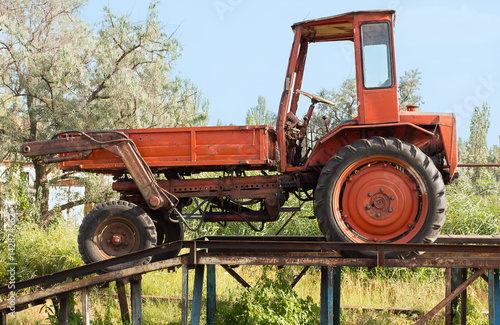 Old red tractor in the countryside photo