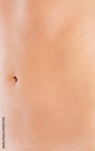 Slim nude young woman belly