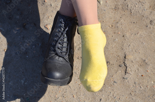 Beautiful legs in yellow socks and black shoes