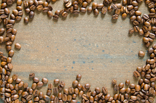 A wood background with coffee bean border suitable for business card or other template