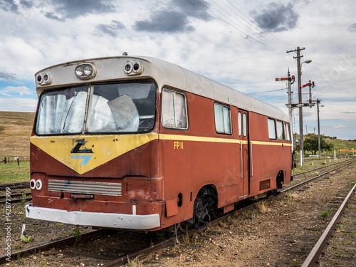 Old train carriage bus restoration parked on train tracks