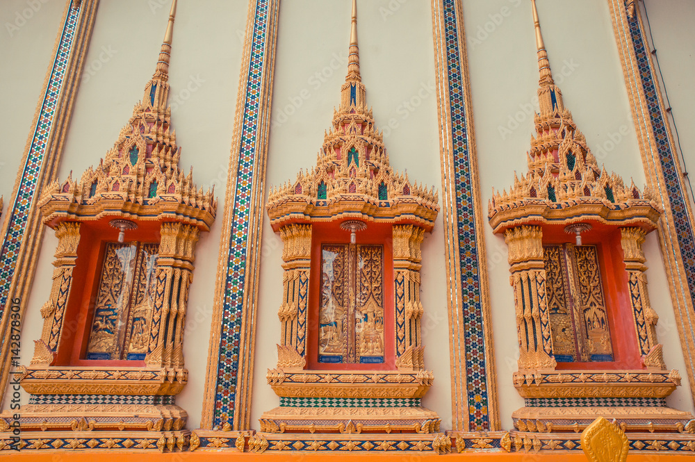 Ancient Thai temple. Wat Kosit Wihan golden Temple Phuket, Thailand. Decor windows architecture wall.