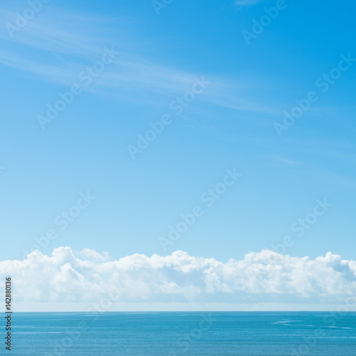 Blue sea with white clouds for background.