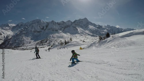 Little boy skiing in the Alps.
Son when skiing. They learn to ski with their parents.