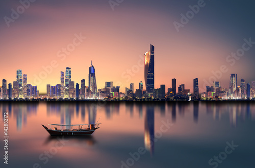 kuwait city skyline during sunset photo
