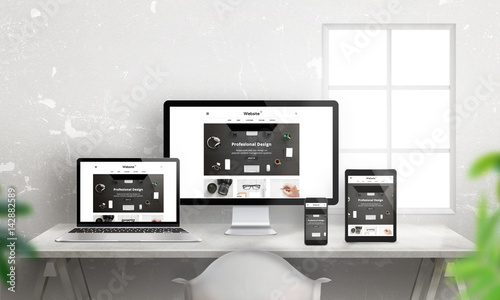 Creative flat responsive web site promotion on different devices. Profesional web design studio. Office desk with devices. Wall and window in background. photo