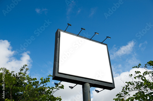 Blank billboard against blue sky.