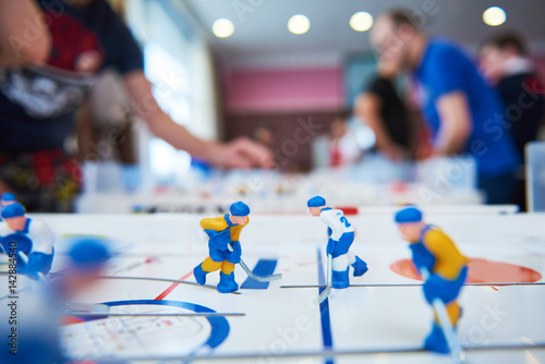 table hockey game with player on background photo