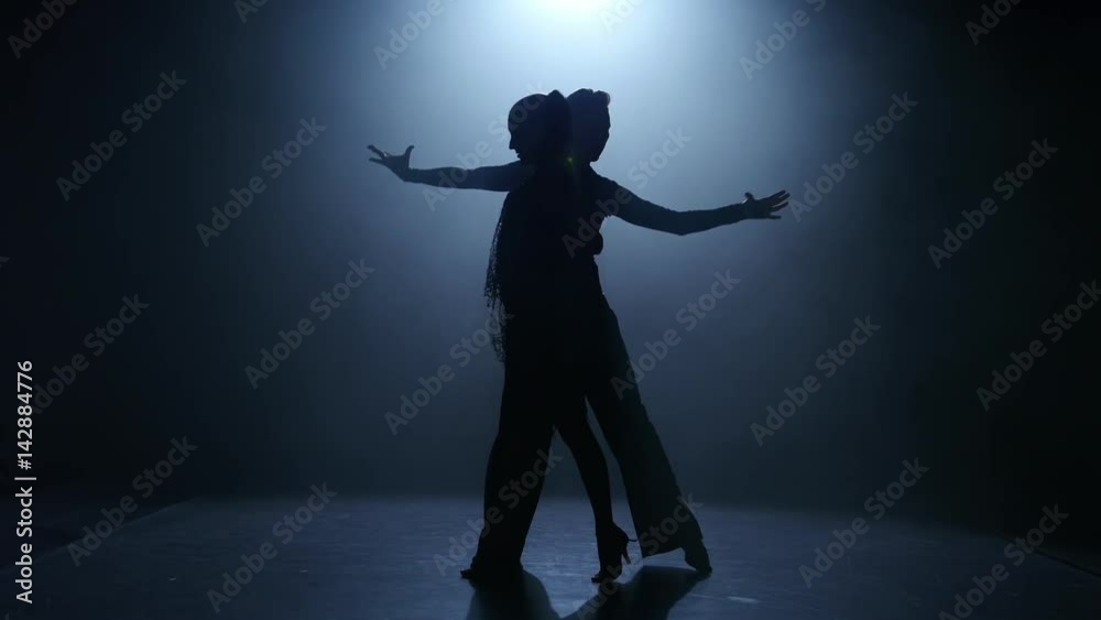 Dance element from the ballroom-sport program, silhouette couple ballroom. Smoke Dance element from the ballroom-sport program, silhouette couple ballroom. Smoke