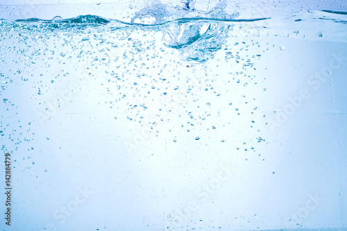 Flowing water, drops, sprays, splashes on a neutral background