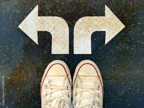 Sneakers shoes with three white arrows print pointing on grunge road , making decision business concept