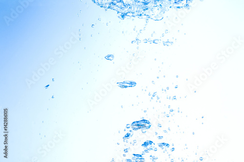 Flowing water, drops, sprays, splashes on a neutral background