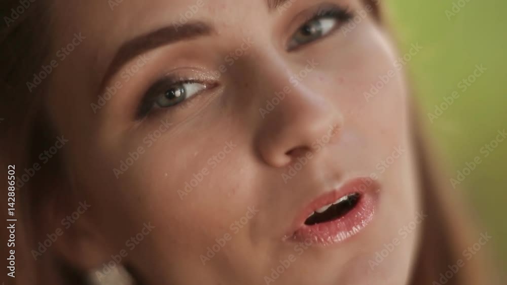 Close-up face of a young girl who sings a song on nature. Close-up face of a young girl who sings a song on nature.