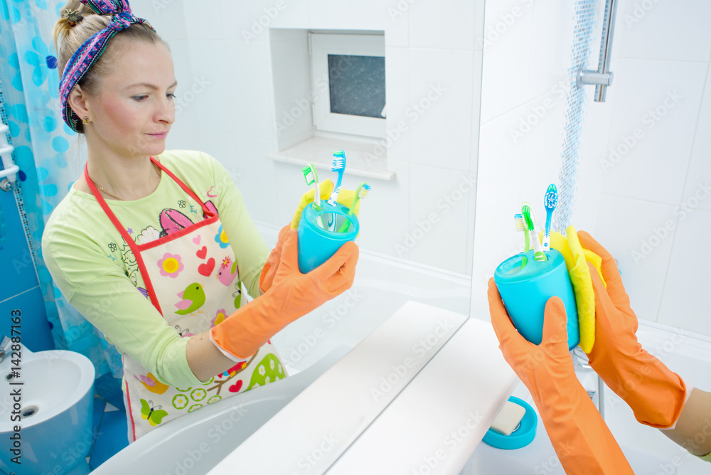Housemaid cleaning a bathroom, closeup shot Housemaid cleaning a bathroom, closeup shot