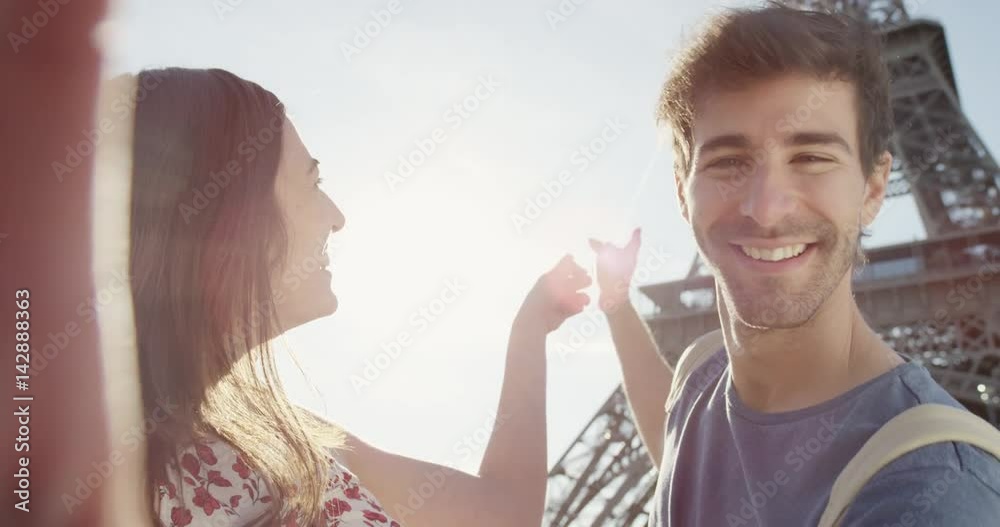 Tourist couple taking selfie under Eiffel Tower Paris smartphone in city sharing lifestyle photo enjoying  holiday European   vacation travel adventure POV