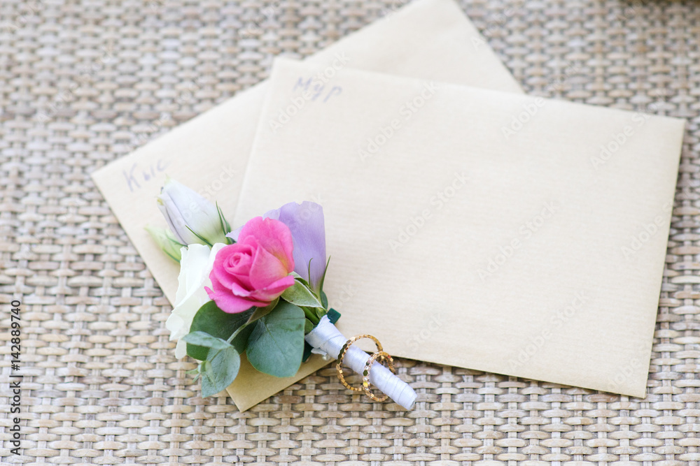 Groom boutonniere and wedding ring Groom boutonniere and wedding ring
