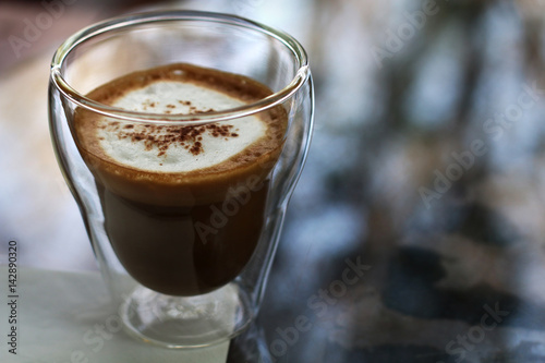 Glass of hot cappuccino coffee