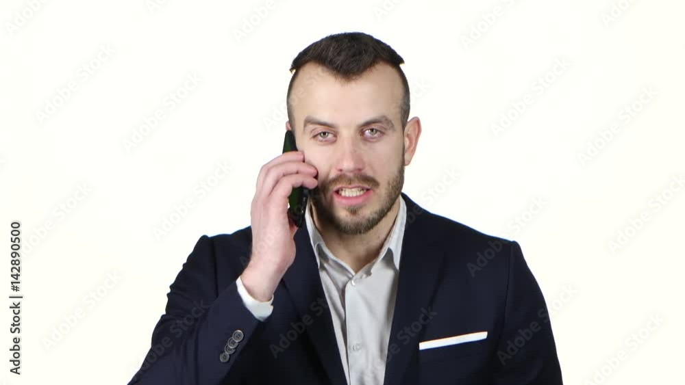 Man exasperated talking on cell phone and screaming. White background Man exasperated talking on cell phone and screaming. White background