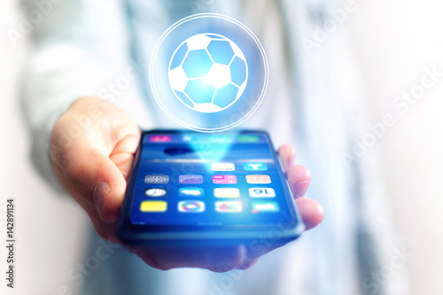 Soccer ball icon over device - Sport and technology concept photo