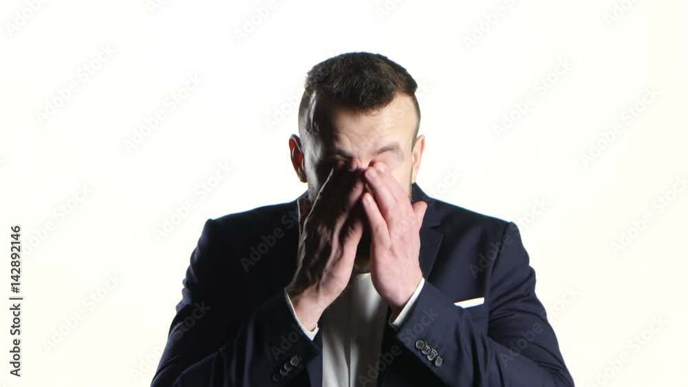 Businessman yawns with a wide open mouth. White background studio Businessman yawns with a wide open mouth. White background studio