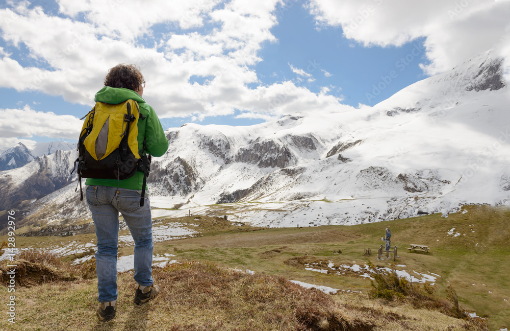 hiker in the Pyrenees mountains in spring with snow