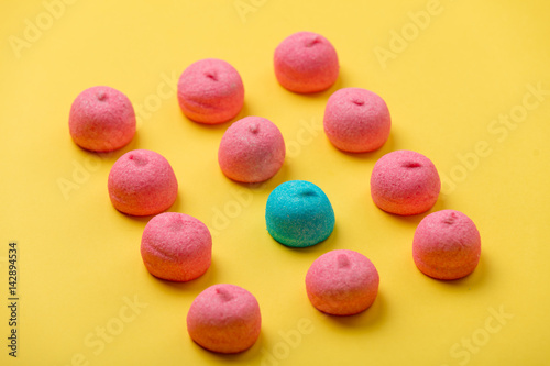 photo of tasty colorful marshmallows on the wonderful yellow background