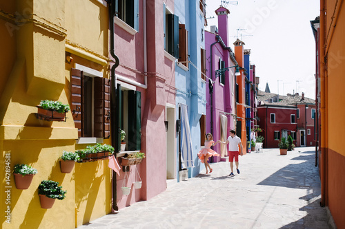 Obraz na płótnie Burano, Venice, Italy - happy couple and colorful buildings w salonie