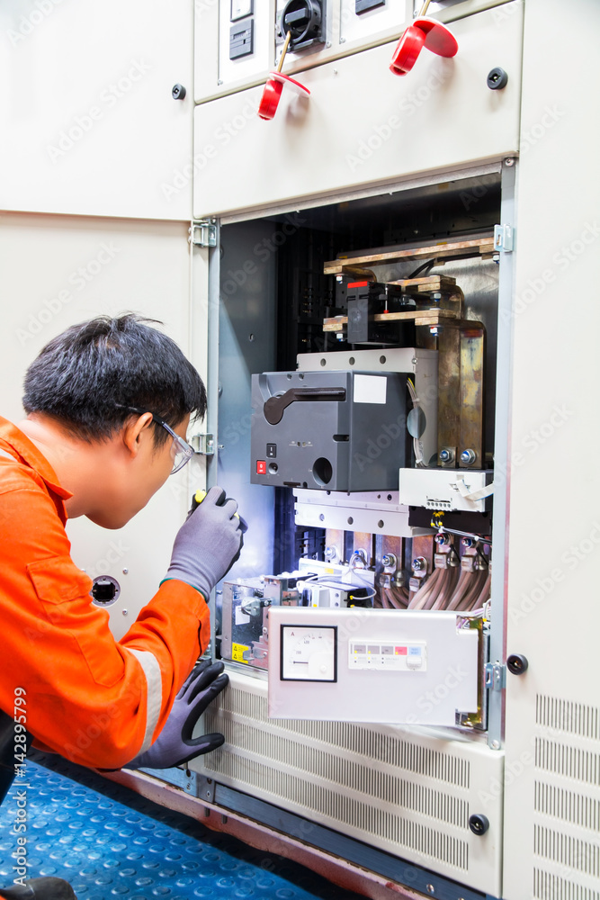 Technician during maintenance an  electrical Motor Soft Starter Drive controller application in industry plant