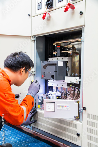 фотографія Technician during maintenance an  electrical Motor Soft Starter Drive controller