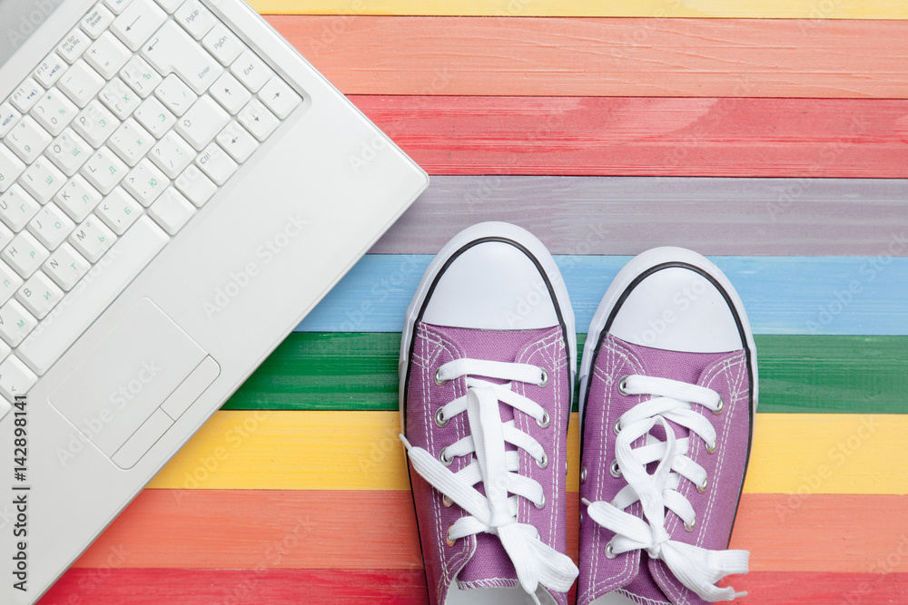 photo of gumshoes and laptop on the wonderful colorful background in pop art style photo of gumshoes and laptop on the wonderful colorful background in pop art style