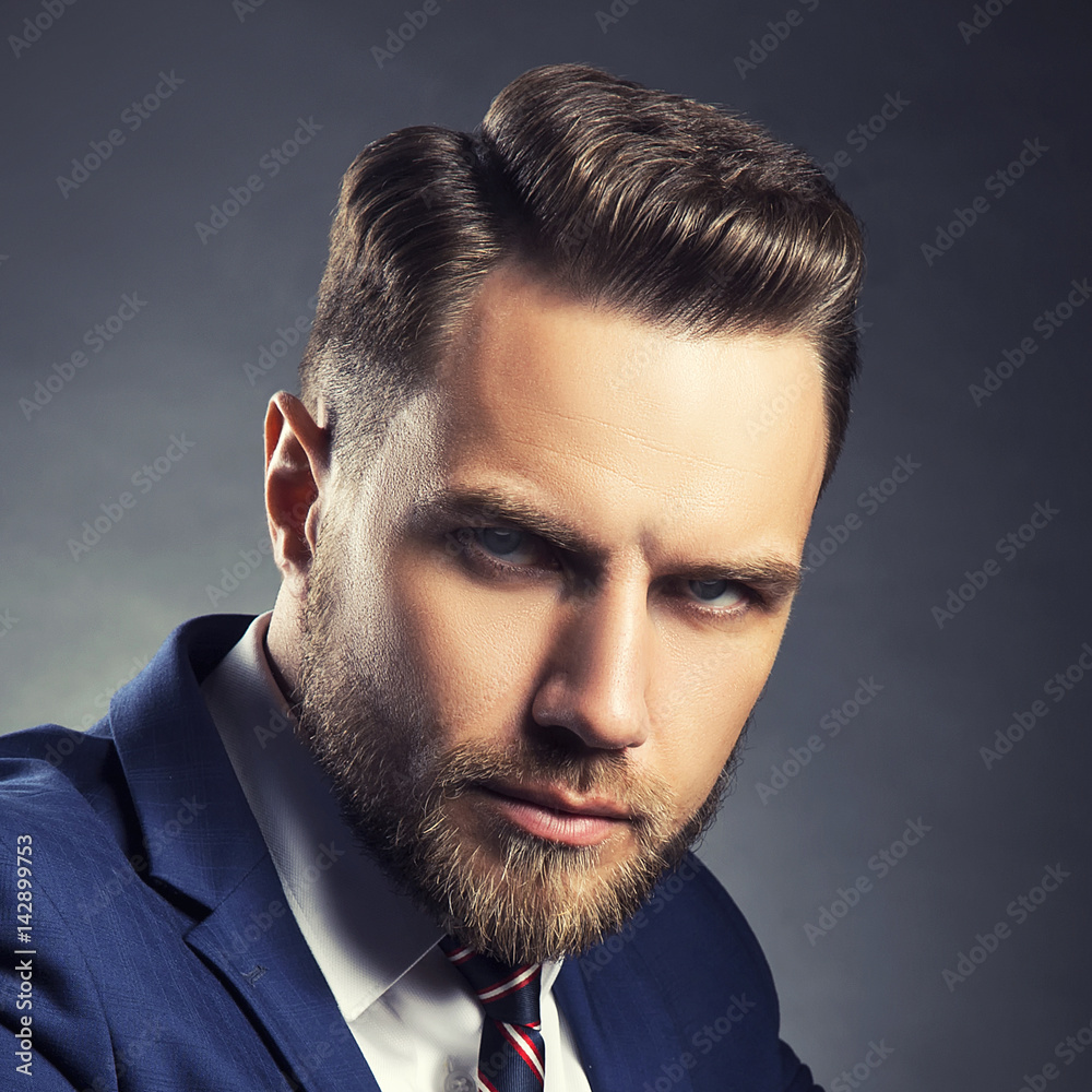 Face of handsome young man with perfect hair style with beard and toned clean skin over dark grey background Stock Photo | Adobe Stock Face of handsome young man with perfect hair style with beard and toned clean skin over dark grey background Stock Photo | Adobe Stock