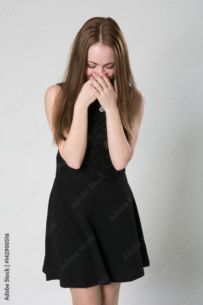 Emotional brunette smiling and covering her mouth Emotional brunette smiling and covering her mouth