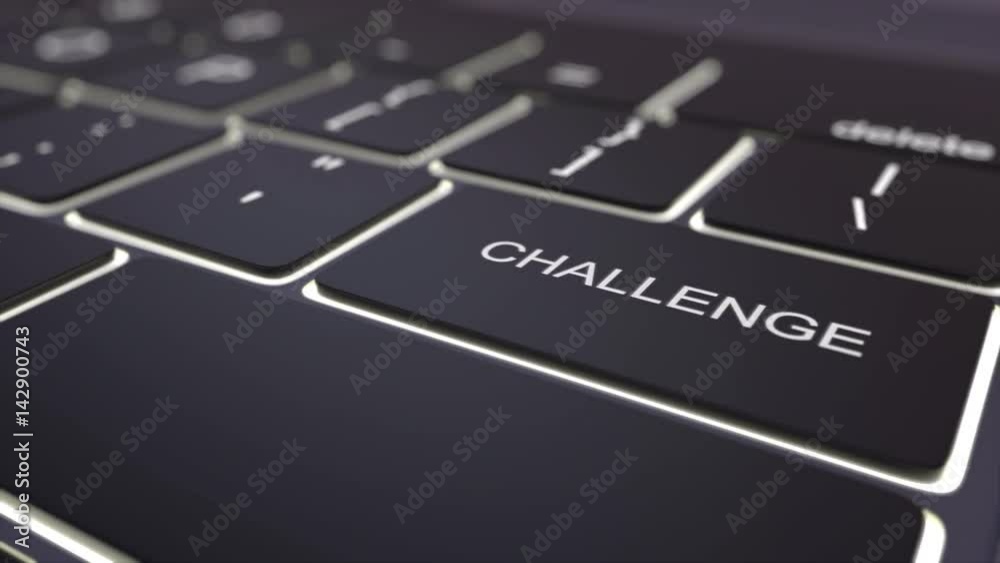 Dolly shot of black luminous computer keyboard and challenge key. Conceptual 4K clip