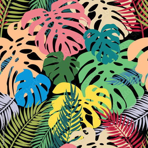 Seamless vector pattern of colorful leaves monstera and palm. Exotic tropical repeat ornament