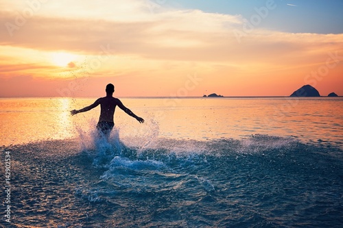 Man running into the sea