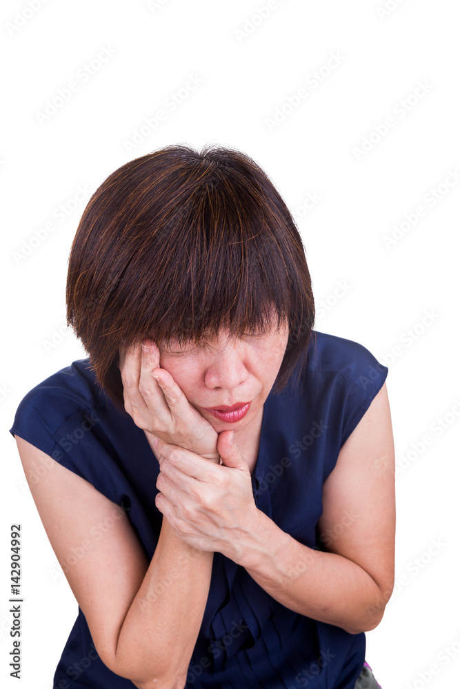 Asian woman suffering intense toothache pain with hands over face