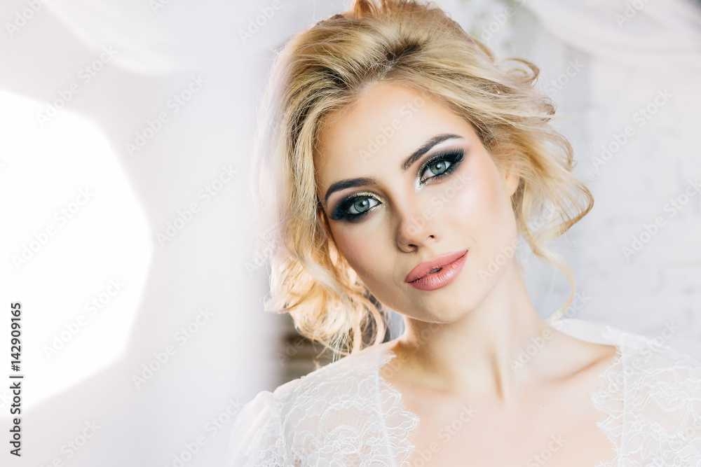 Beautiful model with expressive eyes and beautiful hairdo in white negligee Beautiful model with expressive eyes and beautiful hairdo in white negligee