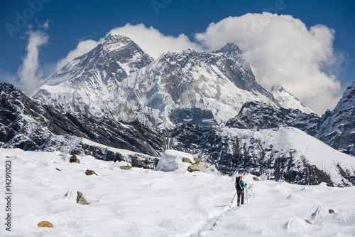 Trekker is walking by Renjo La pass in Everest region © Maygutyak