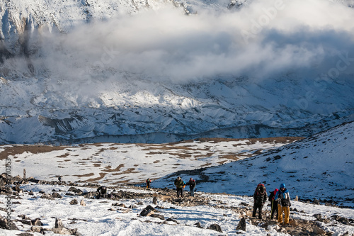 Trekker approaching PumoRi mountain in Khumbu valley on a way to Everest Base camp photo