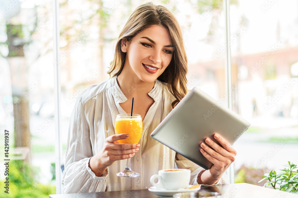 Beautiful woman using digital tablet at cafe Beautiful woman using digital tablet at cafe