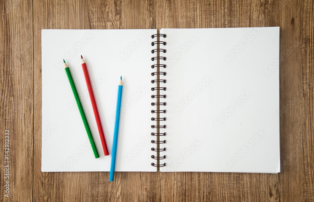 Blank notepad and pencil color on wooden blackground Blank notepad and pencil color on wooden blackground