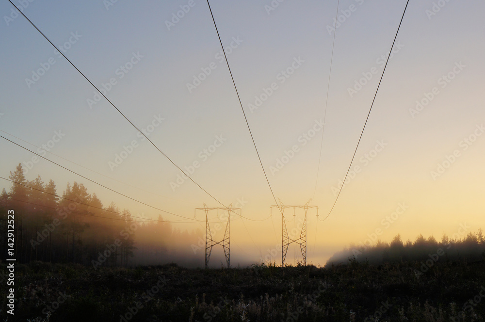 Power line in morning sunrise fog 