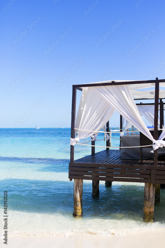 Luxury vacation concept image. Massage place on the beach of the Caribbean sea.