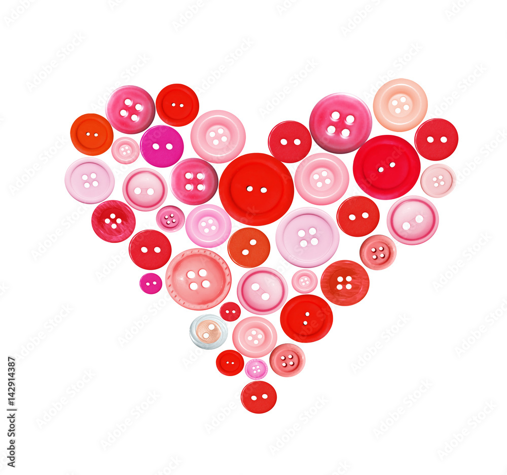Old plastic buttons in a heart shape isolated on white Old plastic buttons in a heart shape isolated on white