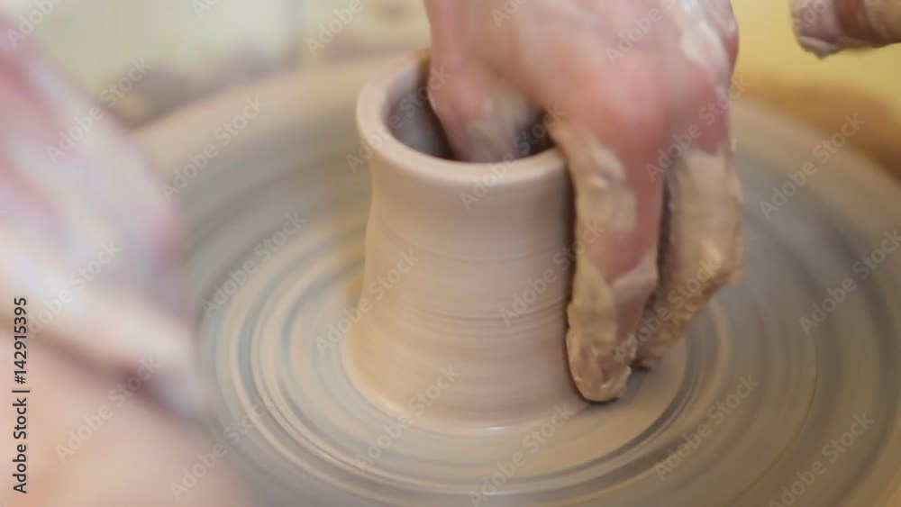 potter teaching how to made a craft cup. close up potter teaching how to made a craft cup. close up