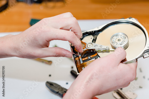 The man repairs a hard drive.