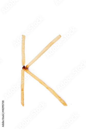 Alphabet letter K laid with french fries. Alphabet letter food.