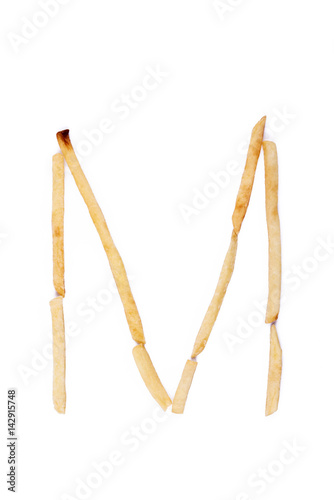 Alphabet letter M laid with french fries. Alphabet letter food.