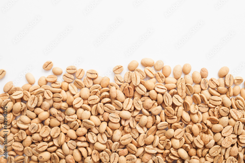 Grains of green coffee on a white background Grains of green coffee on a white background