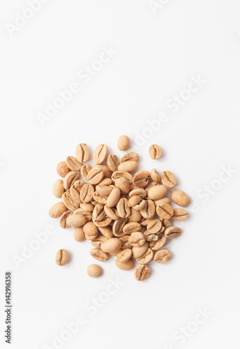 Grains of green coffee on a white background